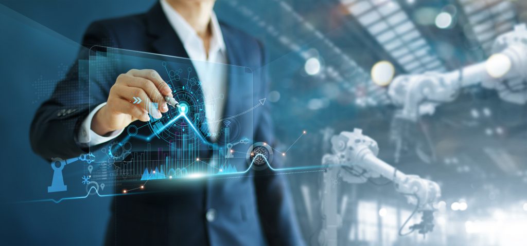 Manager engineer analyzing and control automation robot arms machine on software modern virtual interface data real time in intelligent factory industrial and digital manufacturing operation. 5 Ways ERP Helps Manage a More Agile Manufacturing Process