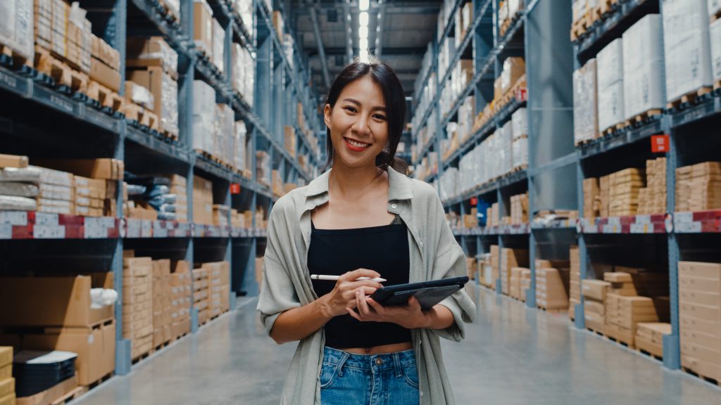 Girl use ERP system in Warehouse